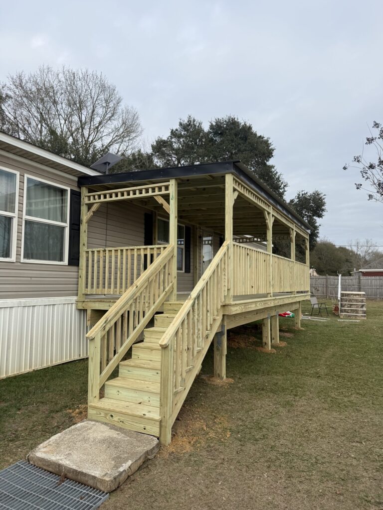Mobile home with steps leading up to a covered mobile home porch